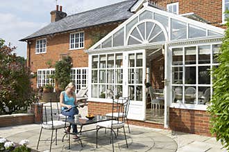 Exterior Of House With Conservatory And Patio