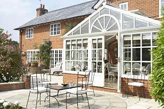 Exterior Of House With Conservatory And Patio