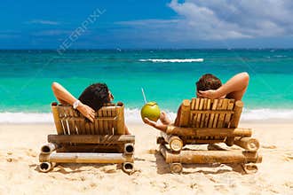 Beach summer couple on island vacation holiday relax in the sun