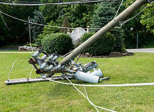Snapped and downed power post and line after storm