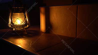 An ancient kerosene lamp burns at night