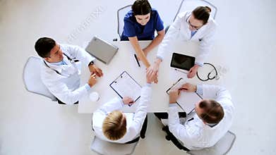 Group of doctors with hands together at hospital