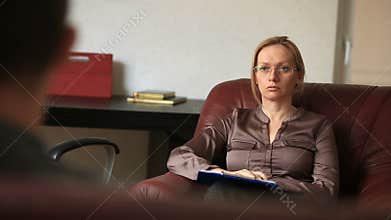 Consultation of a psychologist, a female therapist is consulting a patient with a man with an anxiety disorder