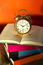 Bedtime reading, alarm clock and books