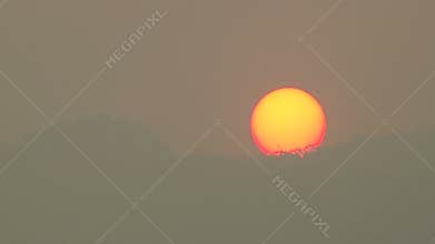 Sunset behind the mountain in the smoke sky