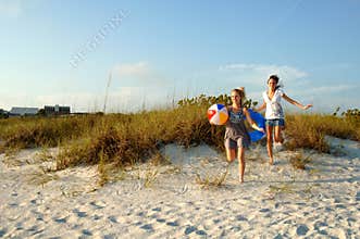 Teens running to the beach