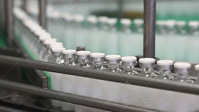 Bottles with drugs on the conveyor line in pharmaceutical factory