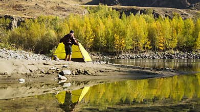 Man setting up his tent for camping