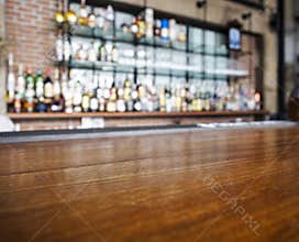 Top of wooden table counter with blurred bar Background