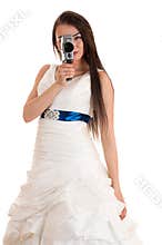 Woman in a wedding dress with the old Soviet video camera