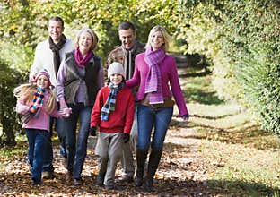 Multi-generation family walking through woods