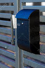 Mailbox on a house fence
