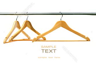 Three coat hangers on a clothes rail