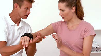Physiotherapist moving patients arm