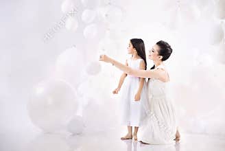 Mom and daughter playing balloons
