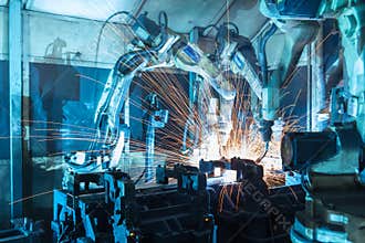 Robots welding in a car factory