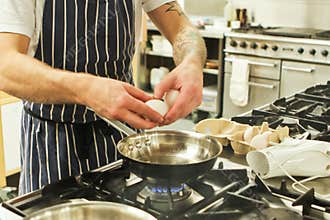 Chef frying eggs