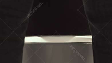 Slowly falling drops in the toilet between male legs