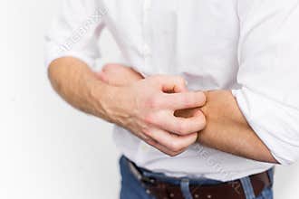 Young man having itchy and dry skin problem