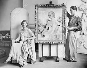 Artist painting portrait of posing woman