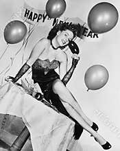 Young woman sitting on a table with balloons and sign