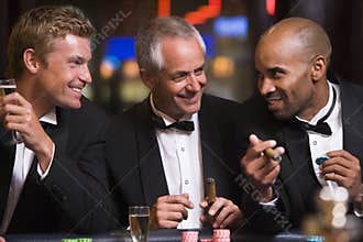 Three men gambling at roulette table