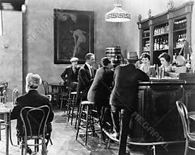 Men sitting around a counter in a bar