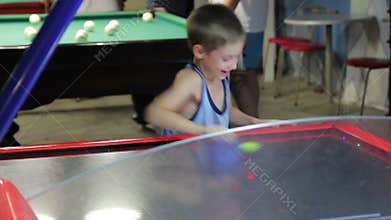 Child playing air hockey, joy and emotion, 1080p
