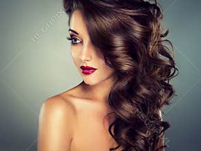 Beautiful model brunette with long curled hair.