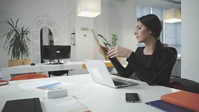 Attractive business woman working at the office and looking at photo frame