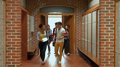 Students walking down hallway to locker