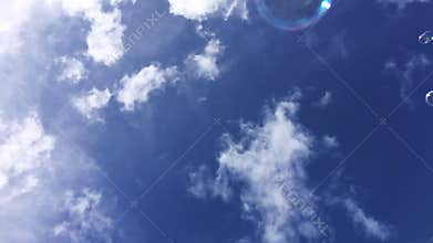 Soap bubbles fly against the sky