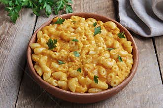 Pasta with pumpkin and cheese creamy in pottery
