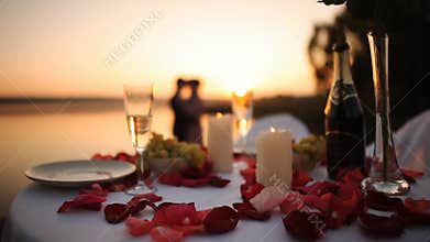 Couple on romantic date at beach restaurant at sunset