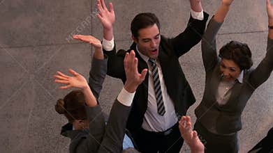 Happy business team putting hands together