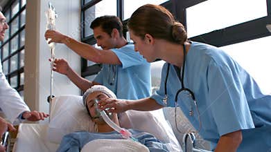 Medical team carrying a patient to intensive care unit