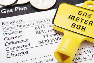 Gas bill with meter key and coins
