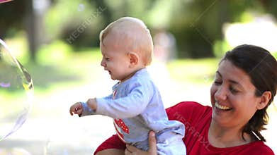 Cute Baby Catching Soap Bubbles