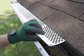 Contractor Adjusting Plastic Gutter Guards