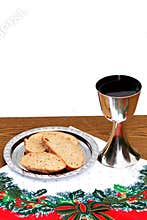 Silver chalice with bread on Christmas background