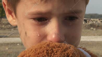 Dirty little orphan boy close-up crying and