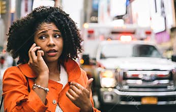 Afro american woman calling 911 in New york city.