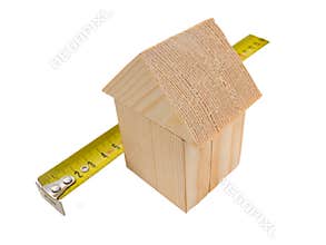 House of wooden building blocks with ruler