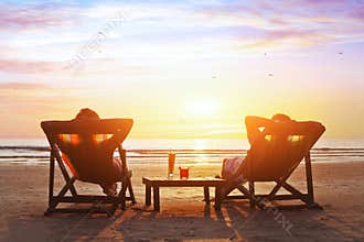 Couple enjoy luxury sunset on the beach