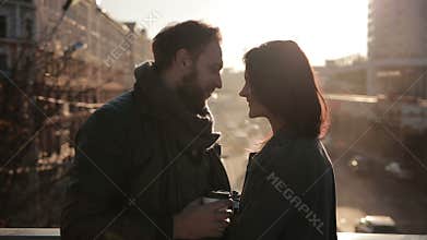 Young couple tenderly embracing on a city bridge