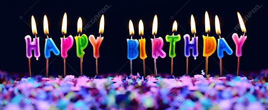 Happy birthday candles and party confetti isolated