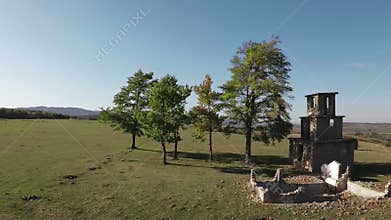 Flying over ruins and trees in autumn