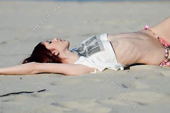 Slim young red hair woman wearing bottom bikini and shirt