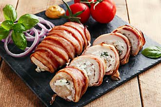 Chicken breast stuffed feta cheese and herbs in bacon