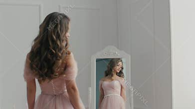 Beautiful bride with the bouquet near the mirror
